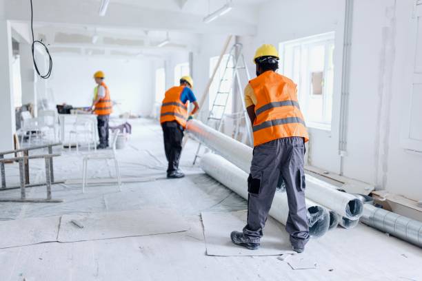 Three construction workers working on a building project